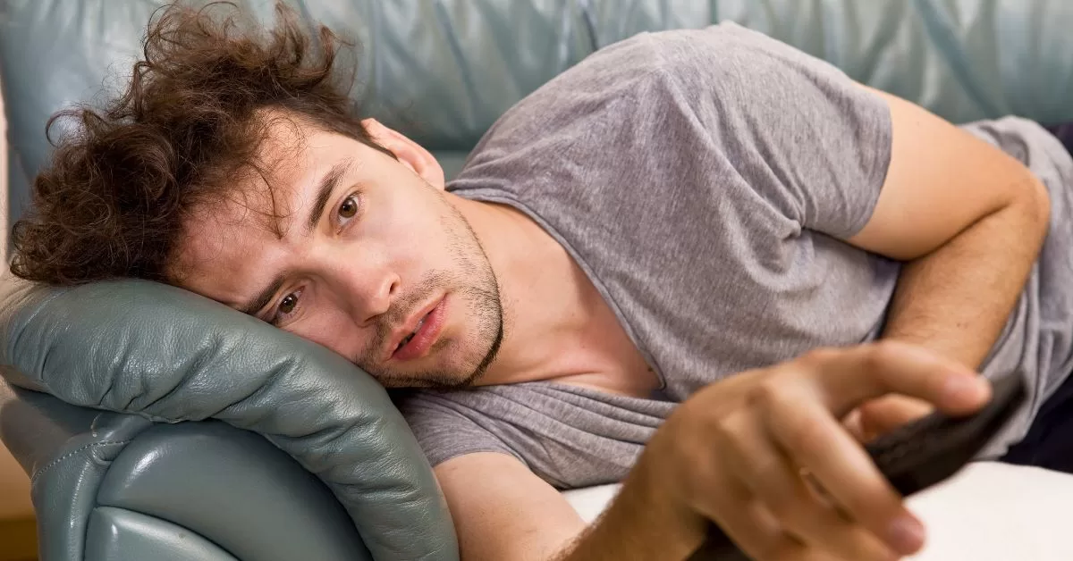 Man slouching on sofa