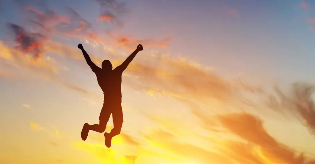 Man jumping for joy at sunset